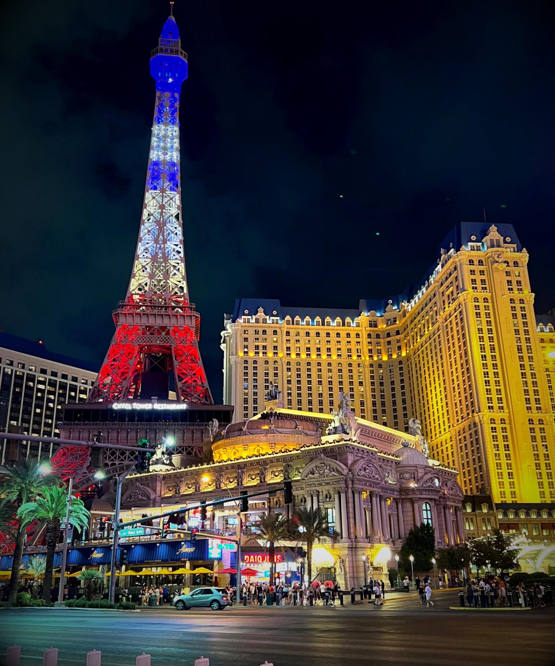 The Eiffel Tower at Paris Las Vegas lit at night in red, white, and blue.