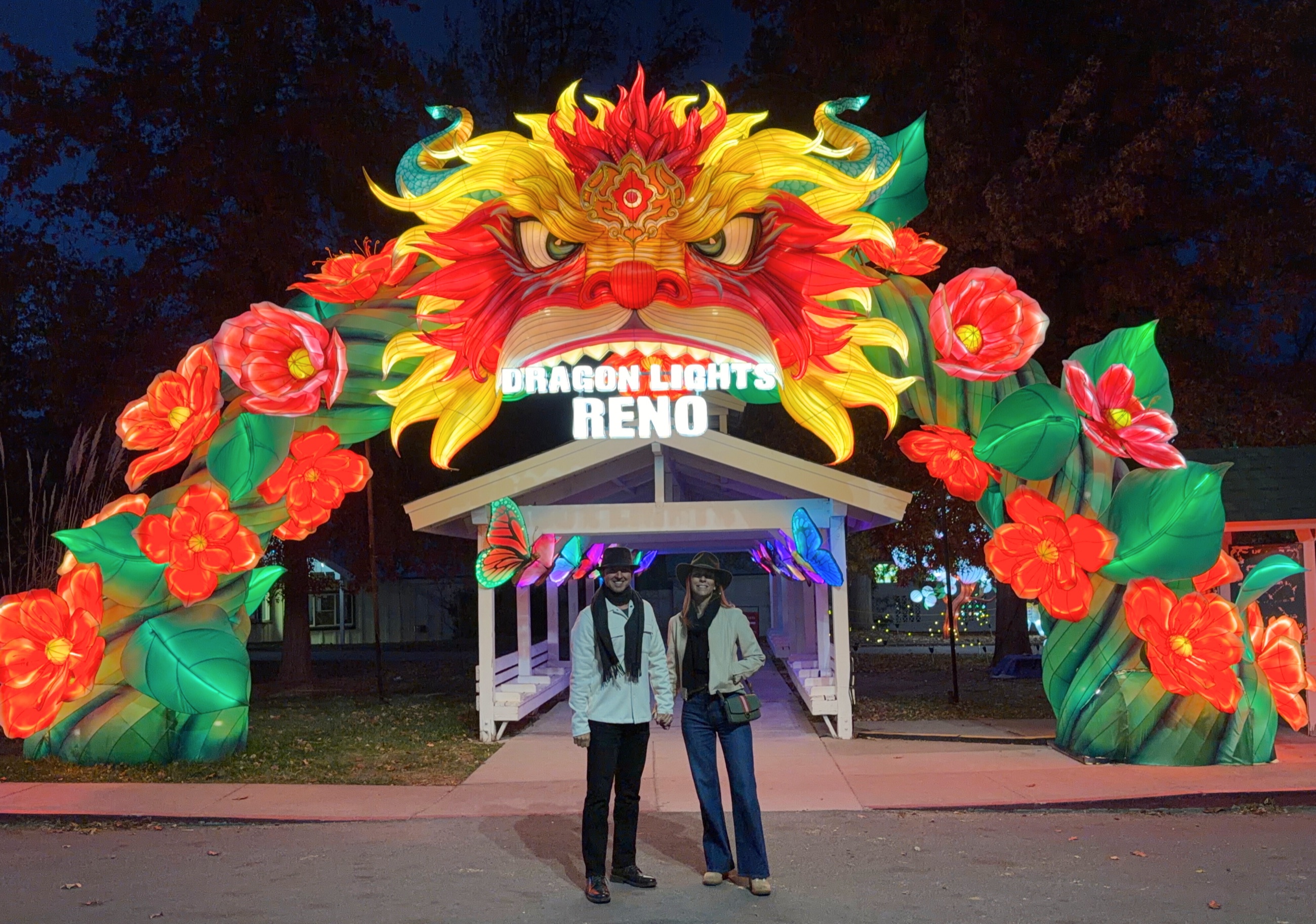 Sam and Stephanie standing beneath the illuminated Dragon Lights Reno entrance at Rancho San Rafael.