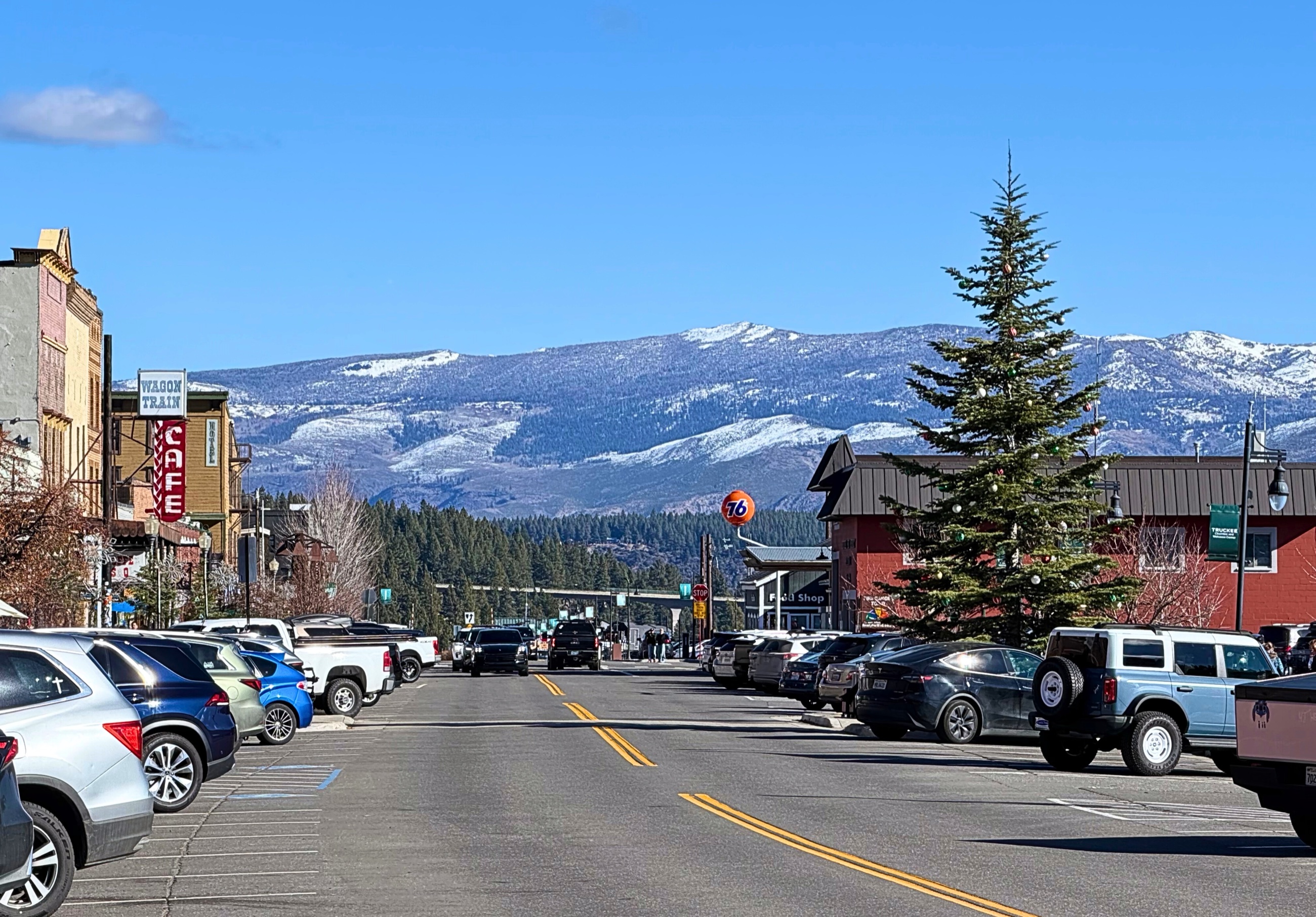 Donner Pass Road through downtown Truckee with snow-covered Sierra ridges beyond.