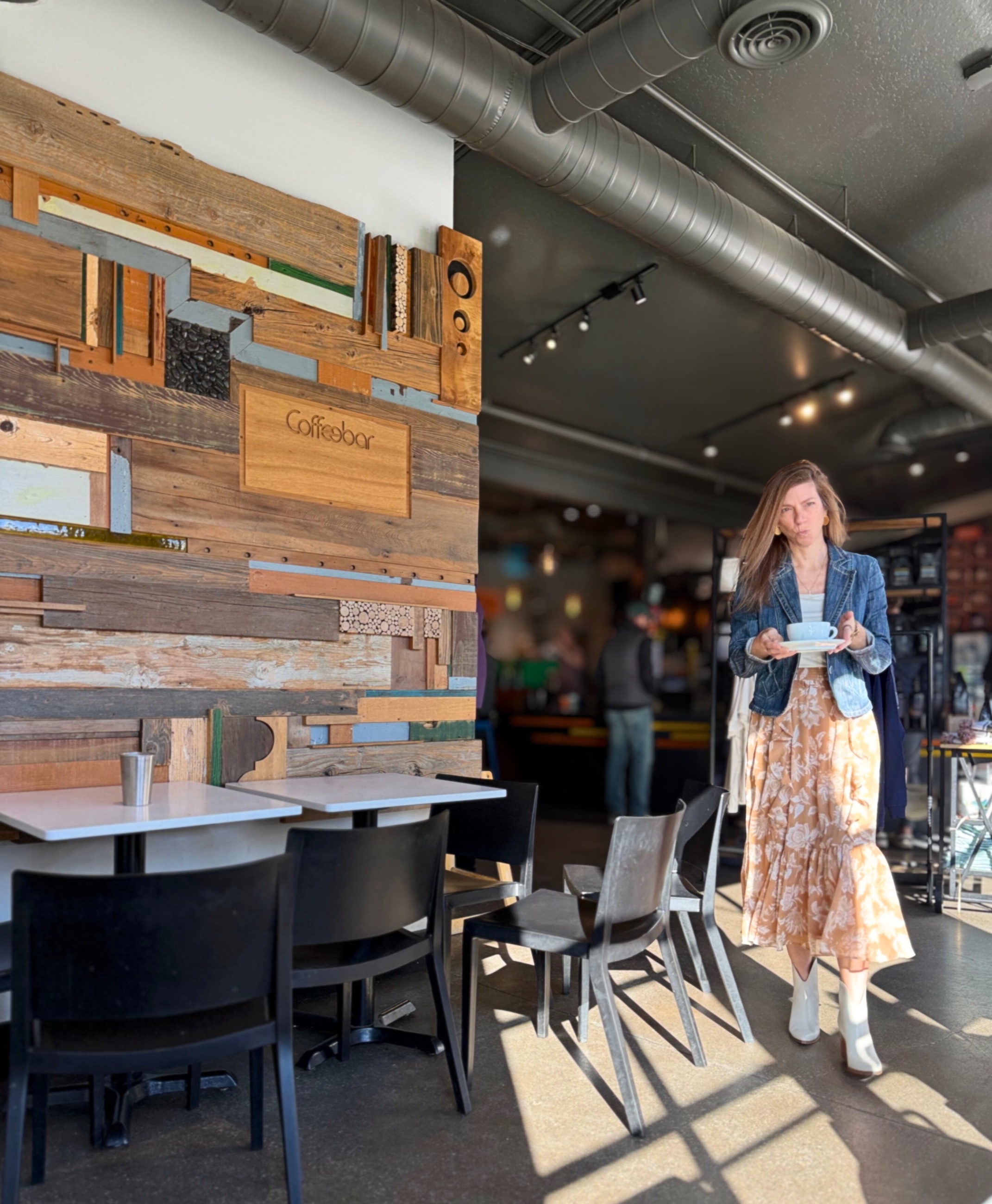 Stephanie carrying coffee inside Coffeebar in Truckee.