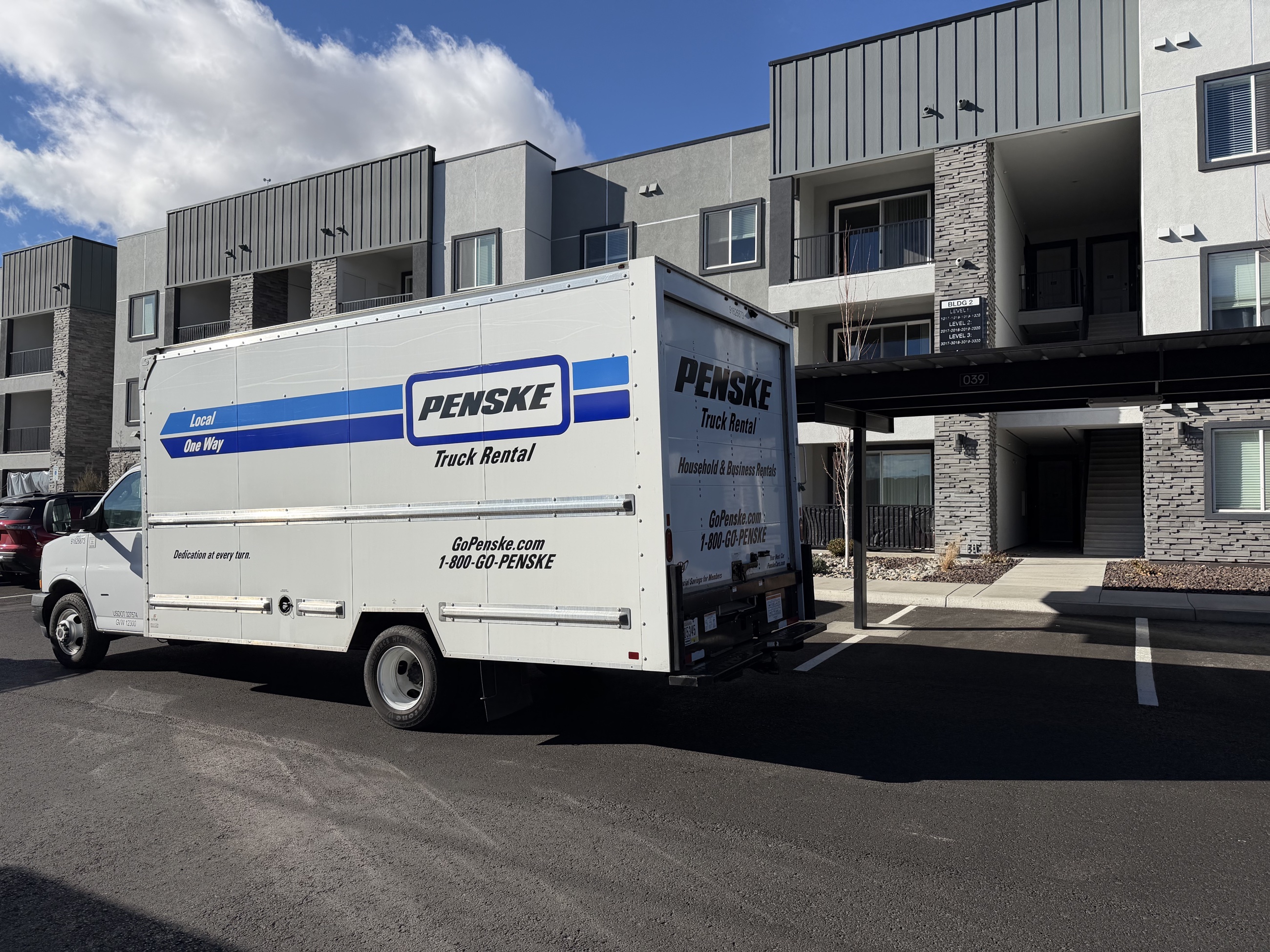 A Penske moving truck parked outside the Reno apartment building on the final loading day.