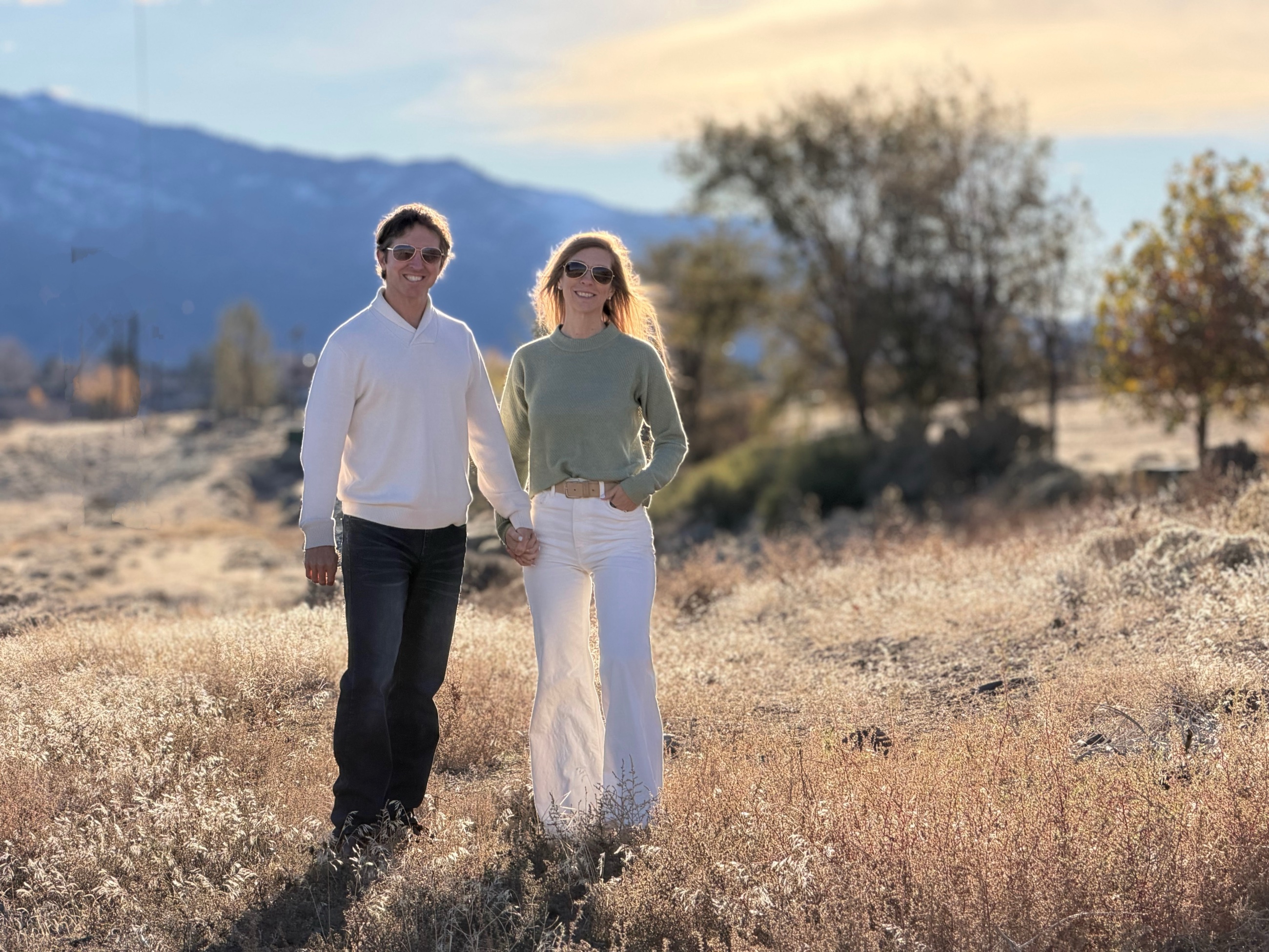 Sam and Stephanie walking together through the sunlit foothills outside Reno, Nevada.