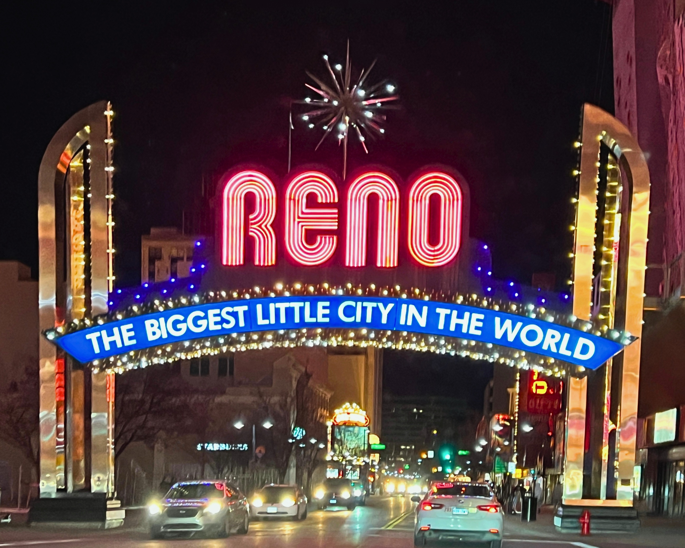 The Reno Arch illuminated above Virginia Street at night