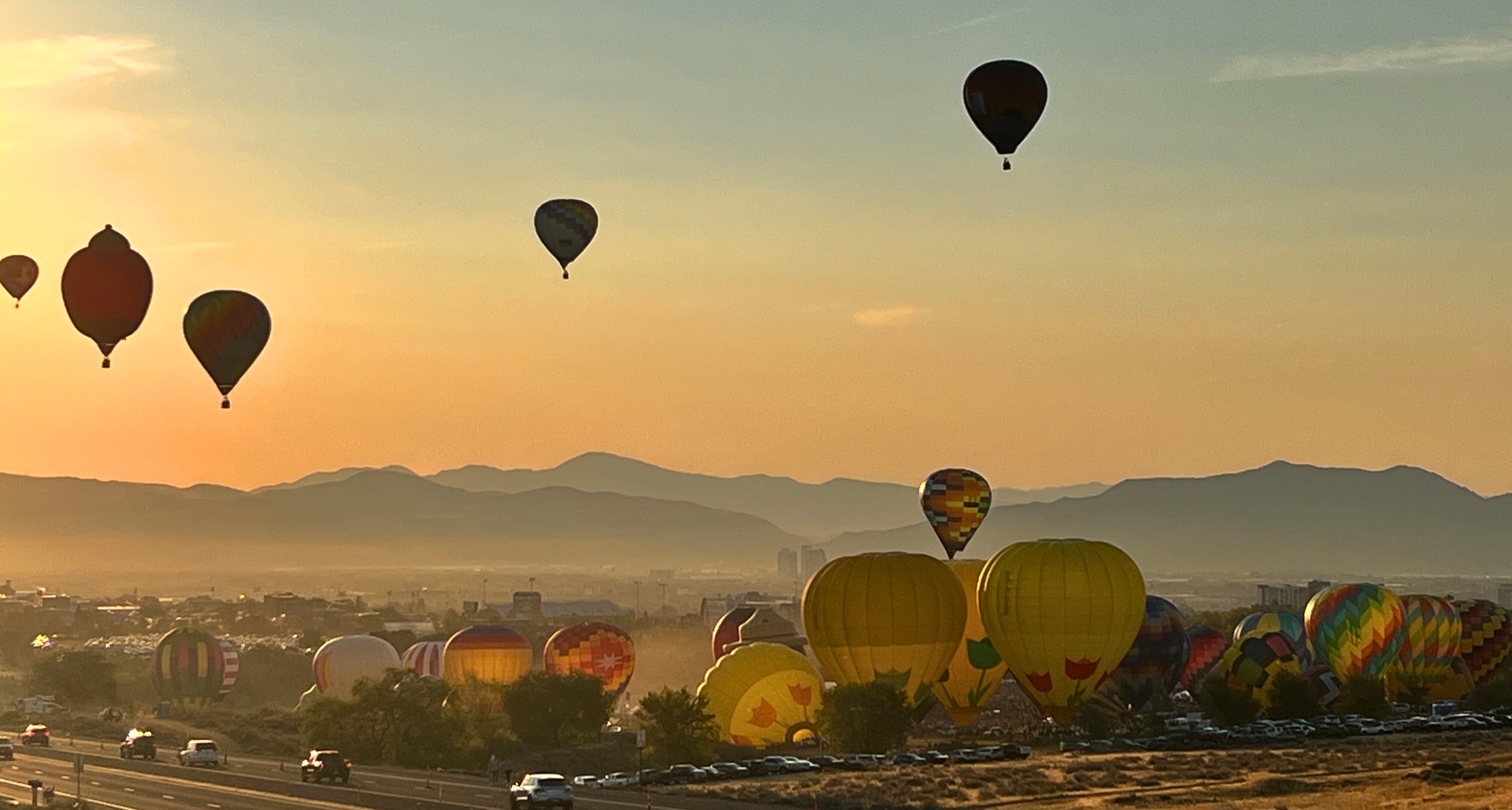 Hot-air balloons rising over Reno at sunrise