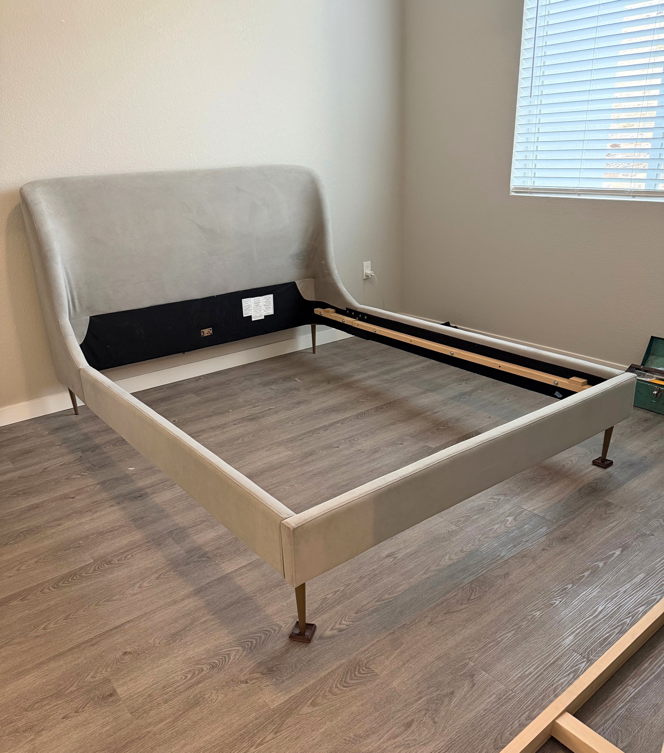 A Reno apartment bedroom with the bed frame partly disassembled and the floor nearly cleared.