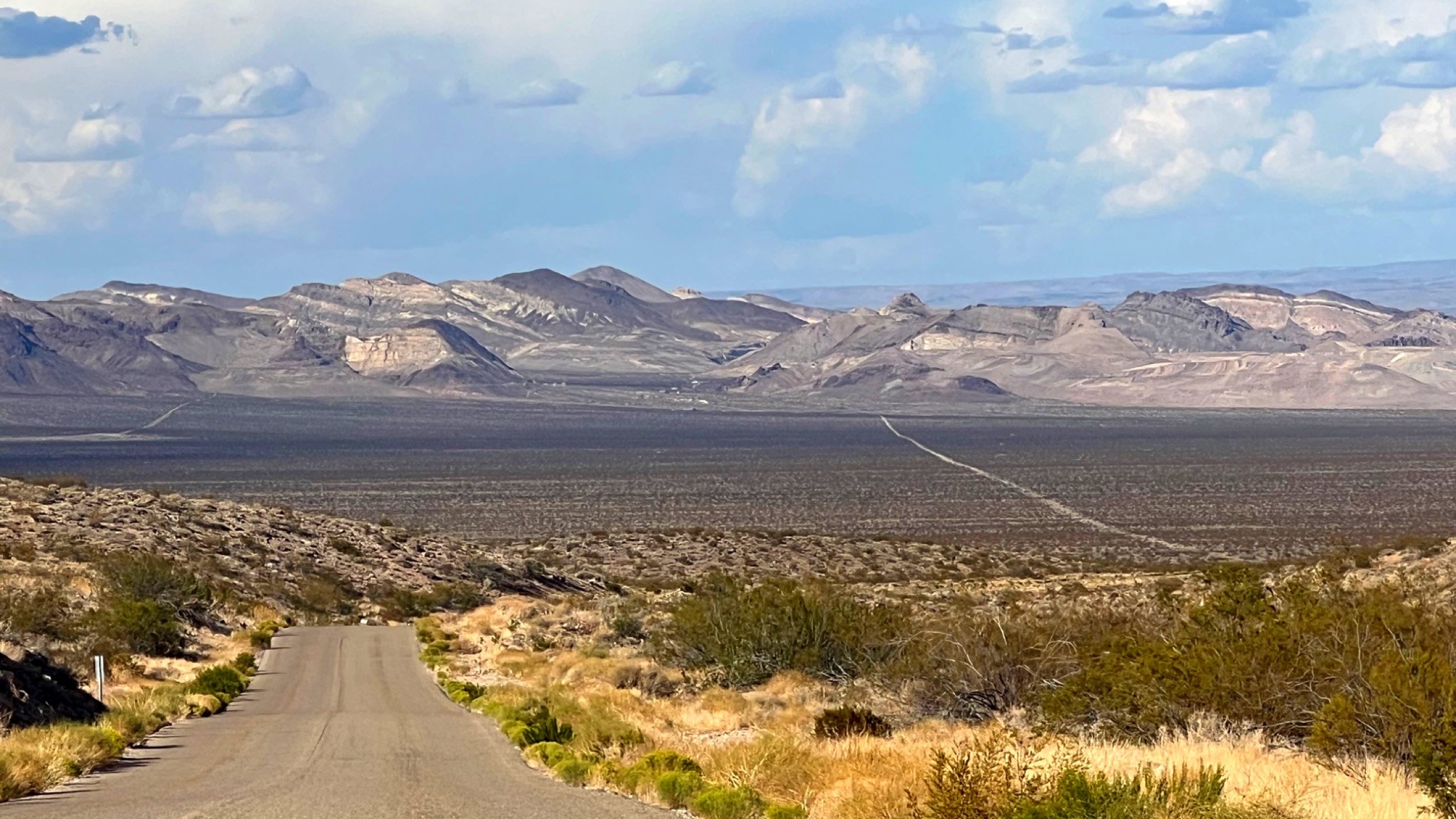 A long desert road stretching across open country.
