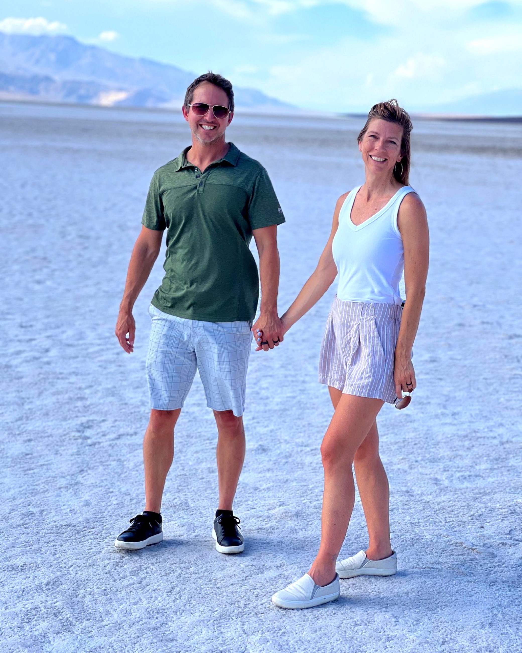 Sam and Stephanie smiling on the salt flats at Badwater Basin.