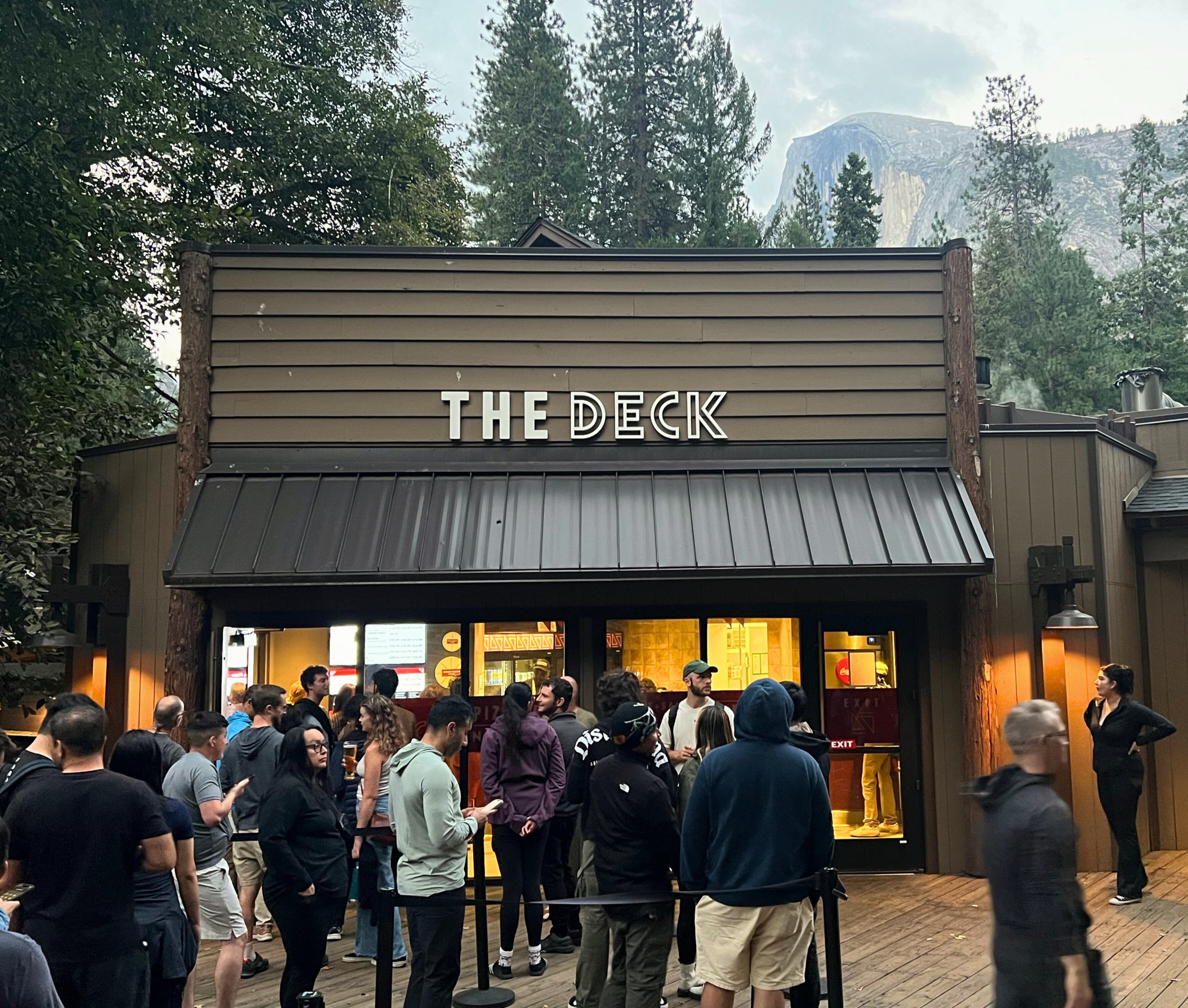People gathered outside The Deck at Curry Village in Yosemite Valley.