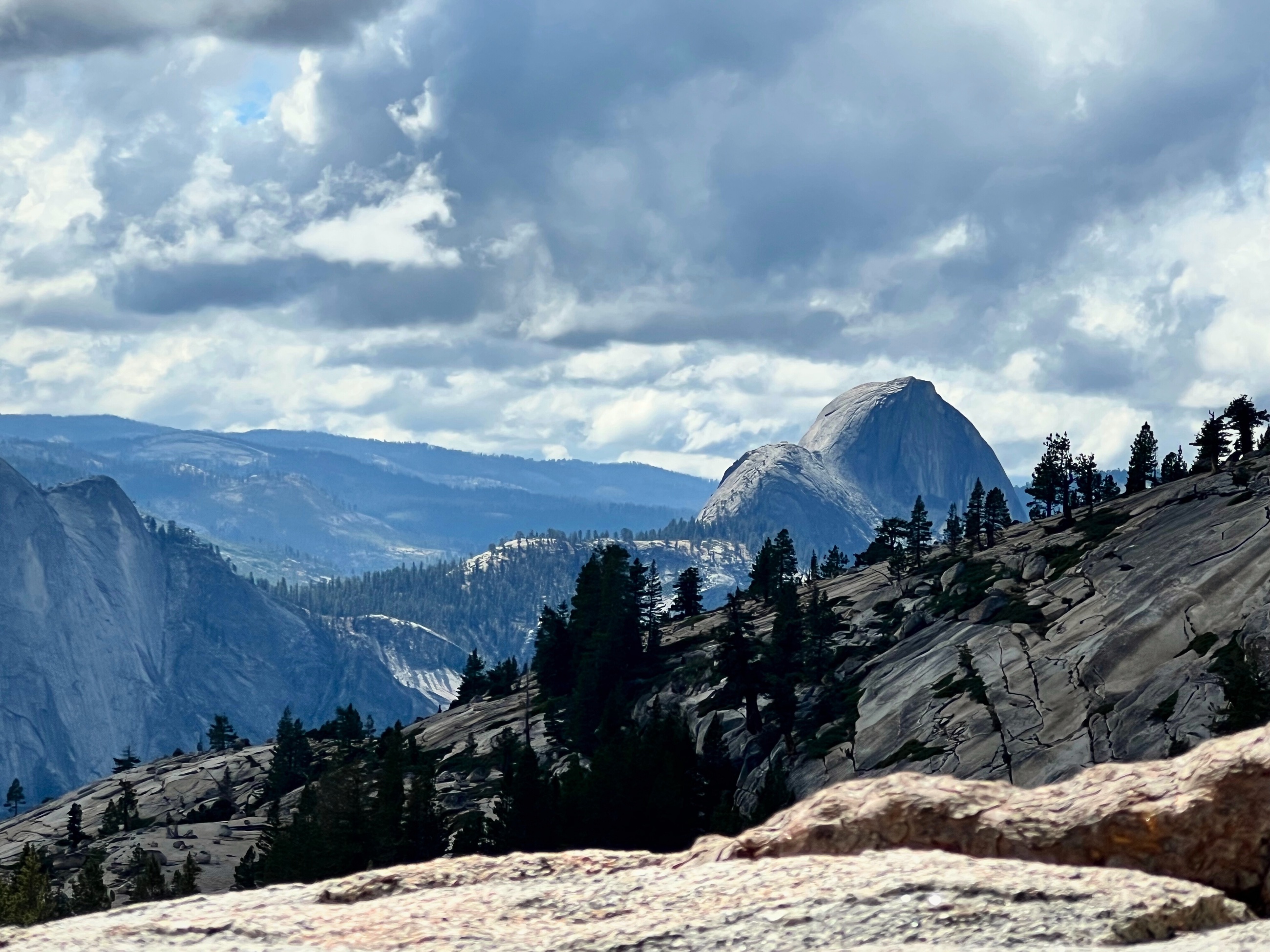 Half Dome beneath storm clouds from the Yosemite high country.