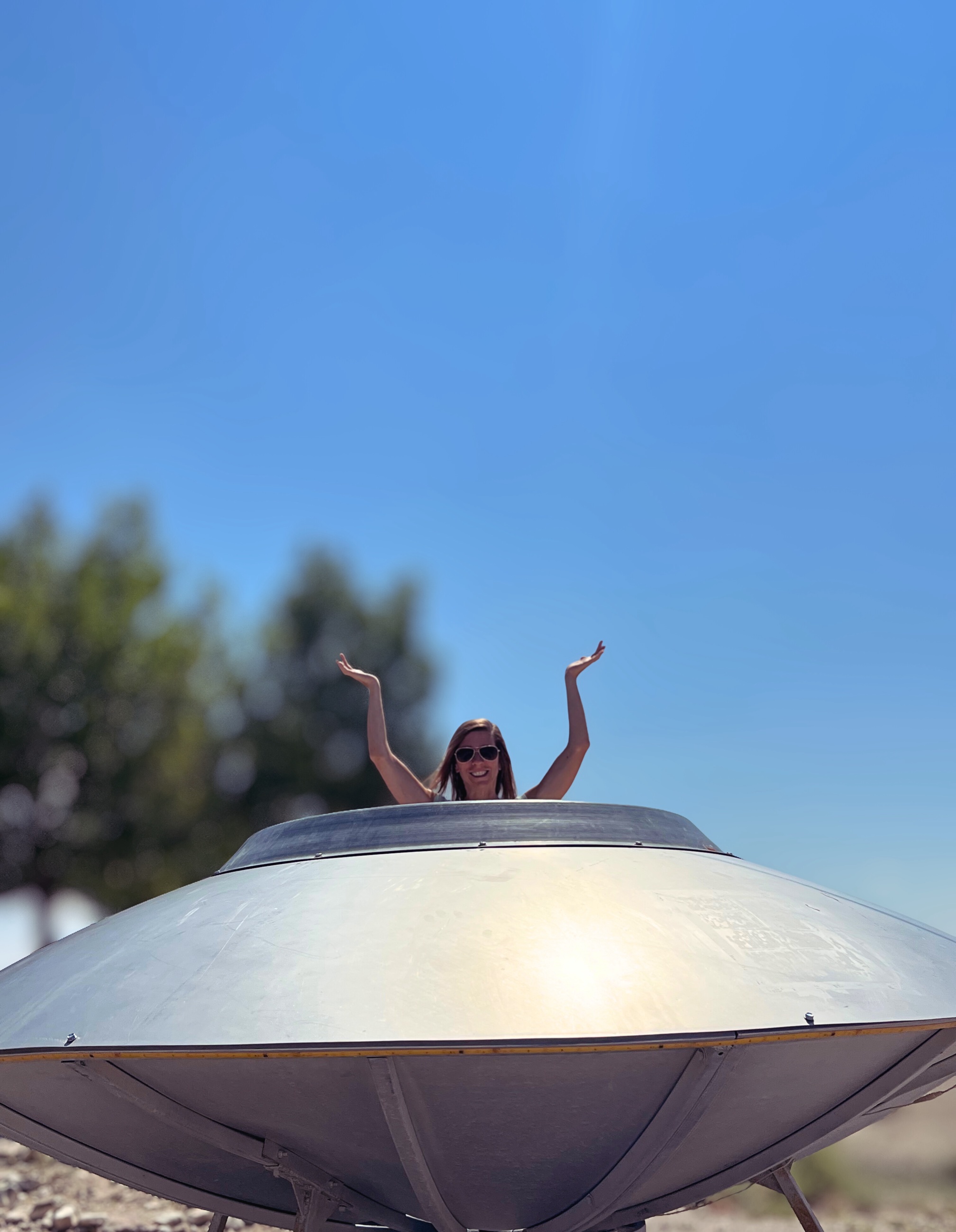 Stephanie sitting inside a roadside UFO display in rural Nevada.