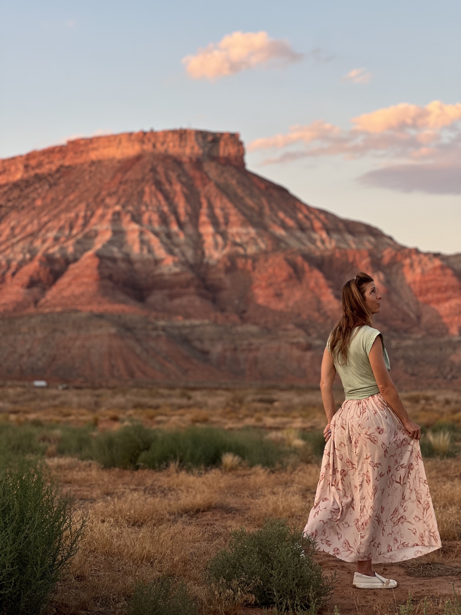 A straight desert road at golden hour on the route toward Zion National Park.