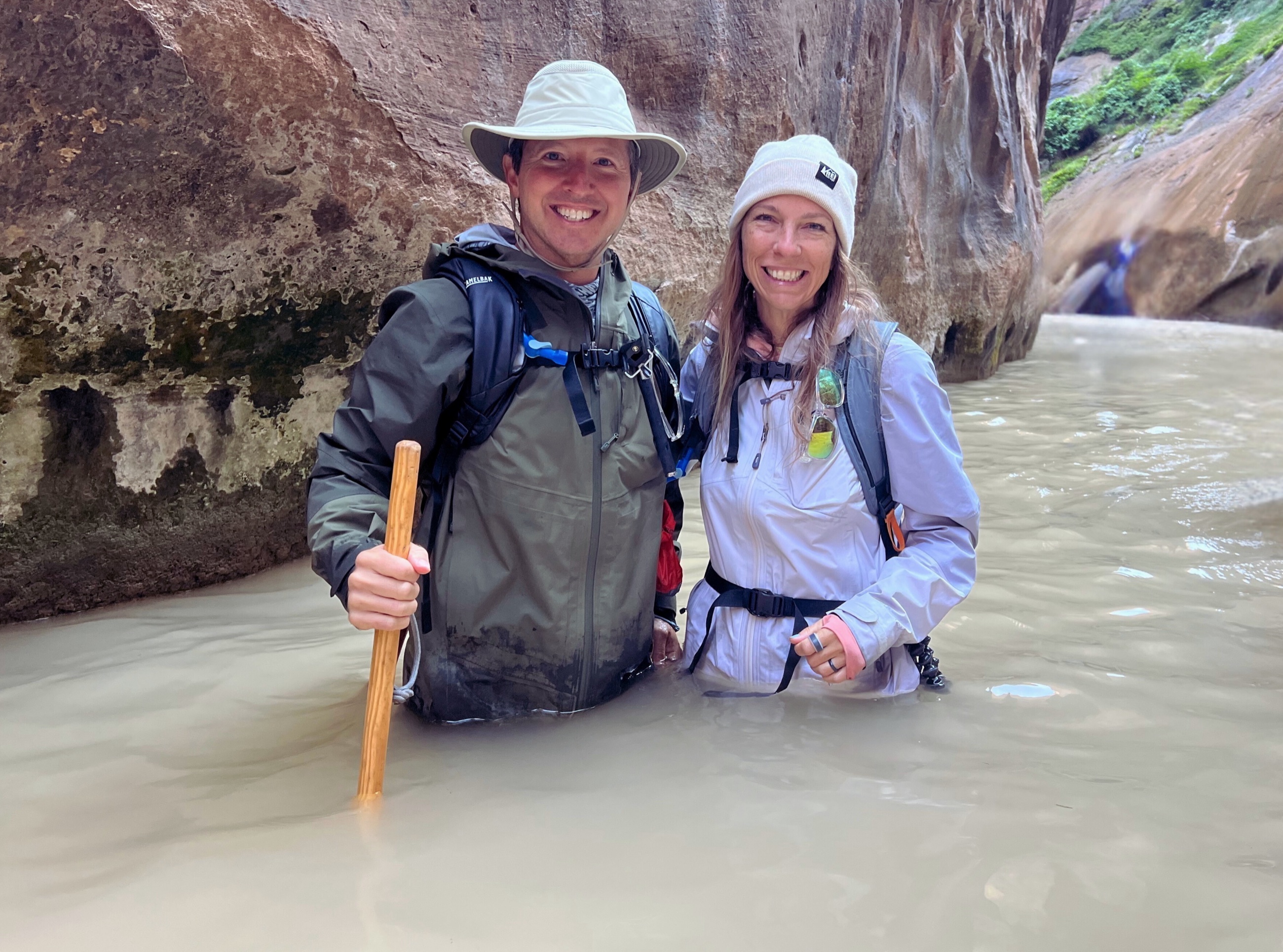 Stephanie wading waist-deep through the Virgin River in the Narrows at Zion National Park.